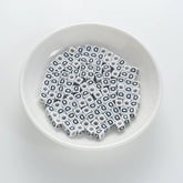 BD00115-01-black-letter-white-opaque-cube-alphabet-beads-single-d-7mm